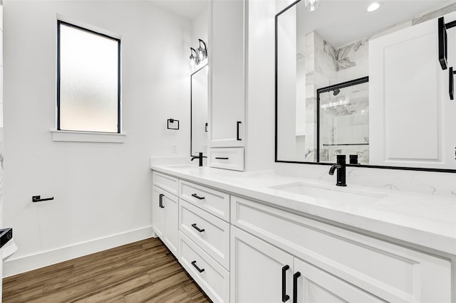 200 Rd 6615, Dayton, TX 77535 - bathroom with a marble finish shower, double vanity, wood finished floors, and recessed lighting