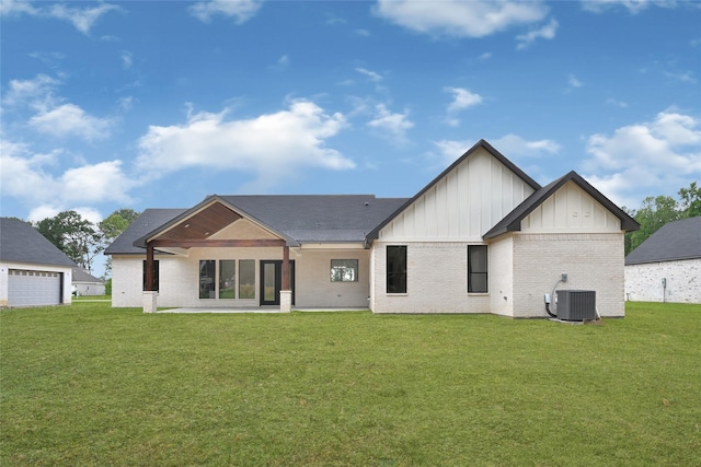 200 Rd 6615, Dayton, TX 77535 - back of property with board and batten siding, a lawn, brick siding, and a garage