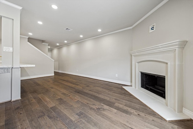 974 Memorial Village Dr Unit 53, Houston, TX 77024 - unfurnished living room with ornamental molding, dark wood-type flooring, recessed lighting, and a fireplace with raised hearth