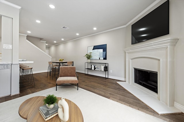 974 Memorial Village Dr Unit 53, Houston, TX 77024 - living area featuring recessed lighting, wood finished floors, ornamental molding, and a fireplace with raised hearth