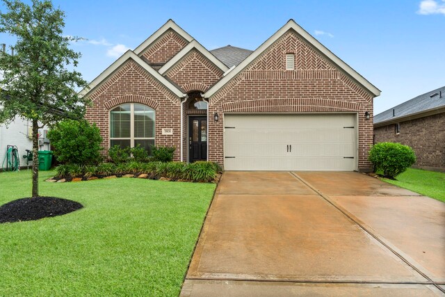 19838 Blue Roan Dr, Tomball, TX 77377 - view of front of house with brick siding, an attached garage, a front yard, and concrete driveway