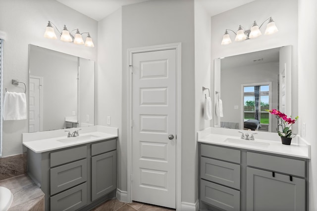 19838 Blue Roan Dr, Tomball, TX 77377 - bathroom with two vanities, ensuite bath, and a tub to relax in