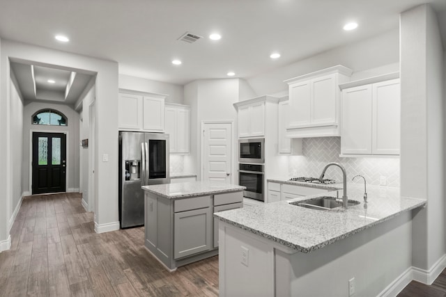 19838 Blue Roan Dr, Tomball, TX 77377 - kitchen with appliances with stainless steel finishes, a center island, dark wood finished floors, and recessed lighting