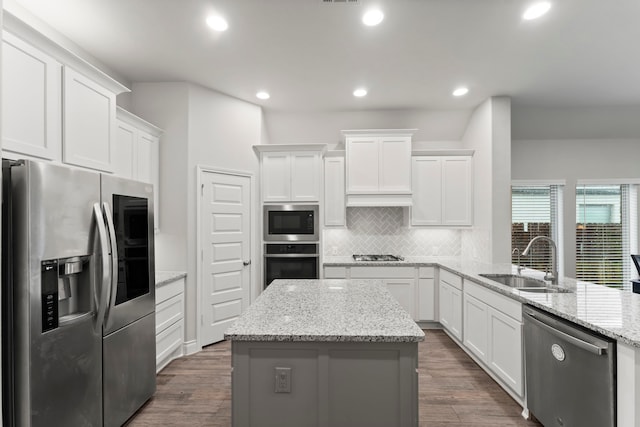 19838 Blue Roan Dr, Tomball, TX 77377 - kitchen with stainless steel appliances, decorative backsplash, white cabinetry, a center island, and recessed lighting