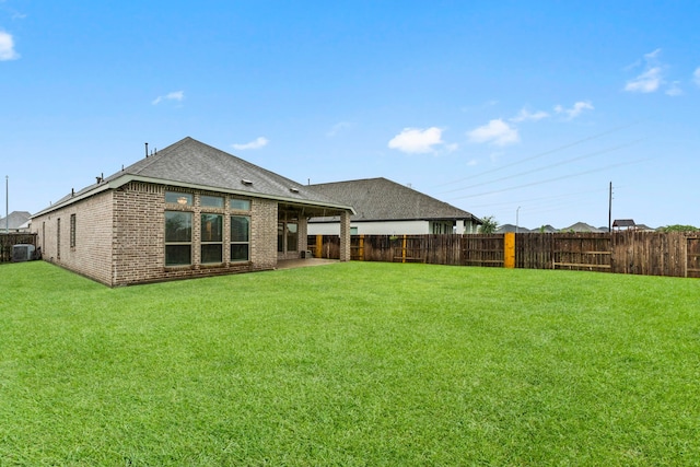 19838 Blue Roan Dr, Tomball, TX 77377 - back of house featuring a fenced backyard, brick siding, and roof with shingles