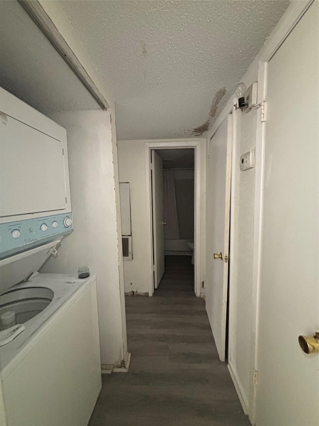 6347 Cattails Ln Unit 63, Houston, TX 77035 - laundry room with stacked washing machine and dryer, dark wood-type flooring, and a textured ceiling