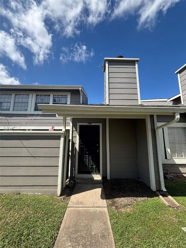 6347 Cattails Ln Unit 63, Houston, TX 77035 - view of front facade featuring a chimney and a metal roof