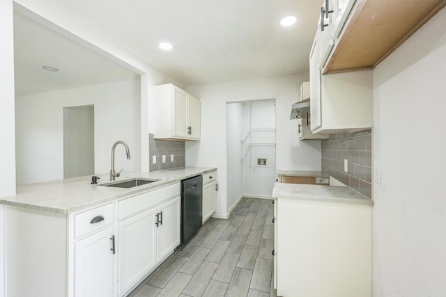 4707 Dove Springs Dr, Austin, TX 78744 - kitchen featuring black dishwasher, a peninsula, decorative backsplash, light wood-style flooring, and white cabinetry