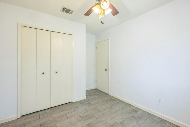 4707 Dove Springs Dr, Austin, TX 78744 - unfurnished bedroom featuring light wood-style flooring, a closet, and a ceiling fan