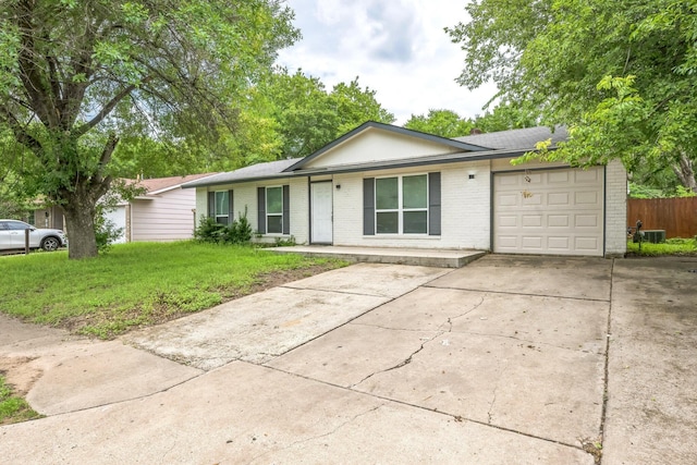 4707 Dove Springs Dr, Austin, TX 78744 - ranch-style house featuring brick siding, an attached garage, driveway, and a front yard