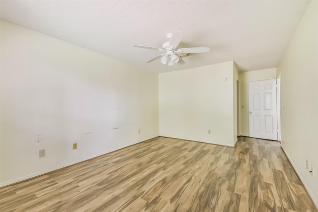 16002 Maple Acres Ct, Houston, TX 77095 - empty room with light wood finished floors, a ceiling fan, and a textured ceiling
