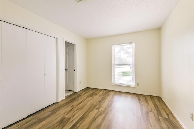 16002 Maple Acres Ct, Houston, TX 77095 - unfurnished bedroom with light wood-type flooring and a closet