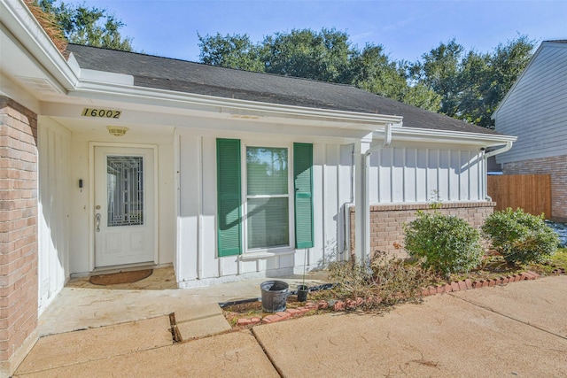 16002 Maple Acres Ct, Houston, TX 77095 - entrance to property with board and batten siding, brick siding, a shingled roof, and covered porch