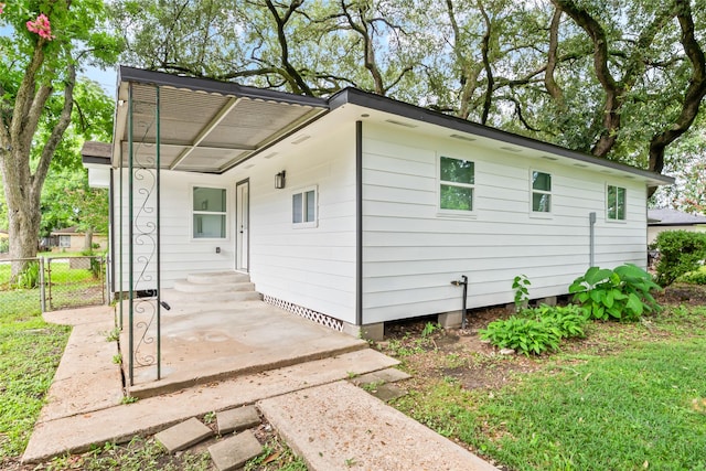 153 E Rittenhouse St, Houston, TX 77076 - back of property featuring an attached carport and a gate