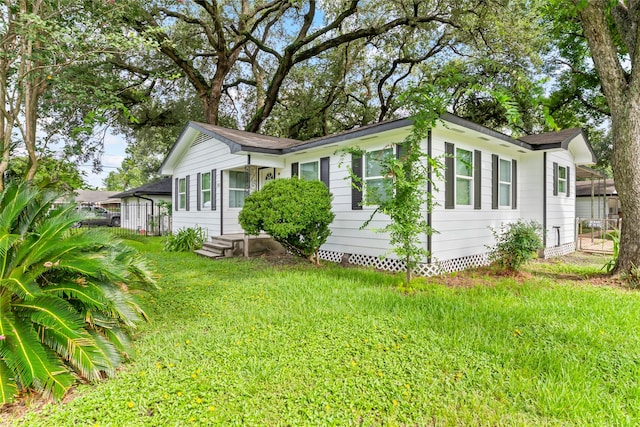 153 E Rittenhouse St, Houston, TX 77076 - view of property exterior featuring crawl space and a lawn