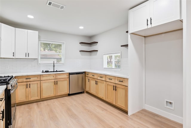 153 E Rittenhouse St, Houston, TX 77076 - kitchen featuring stainless steel appliances, open shelves, light wood-type flooring, light countertops, and recessed lighting