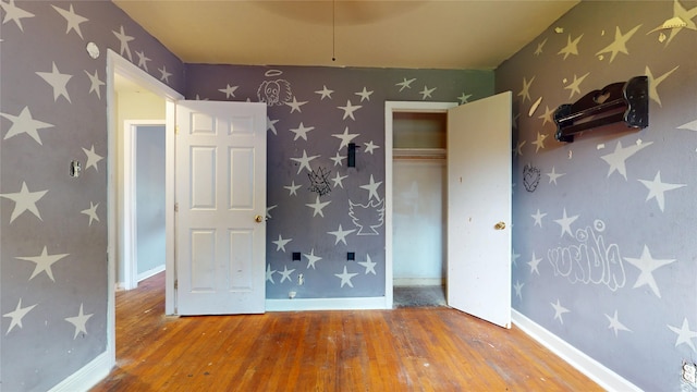 907 Axilda St, Houston, TX 77017 - unfurnished bedroom with wood-type flooring, a closet, and wallpapered walls