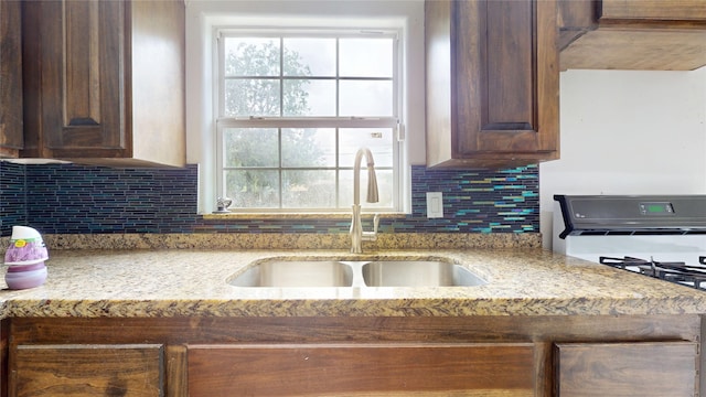 907 Axilda St, Houston, TX 77017 - kitchen featuring gas stove, plenty of natural light, light stone counters, and tasteful backsplash