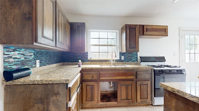 907 Axilda St, Houston, TX 77017 - kitchen with gas range gas stove, tasteful backsplash, and light tile patterned floors