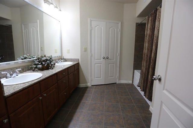 1711 Old Spanish Trl Unit 310, Houston, TX 77054 - full bath featuring double vanity, shower / bathtub combination with curtain, and tile patterned flooring