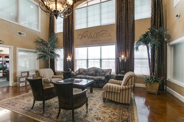 1711 Old Spanish Trl Unit 310, Houston, TX 77054 - living room with a towering ceiling, finished concrete floors, a chandelier, and healthy amount of natural light