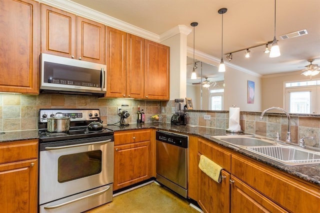 1711 Old Spanish Trl Unit 310, Houston, TX 77054 - kitchen with stainless steel appliances, ceiling fan, ornamental molding, brown cabinetry, and plenty of natural light