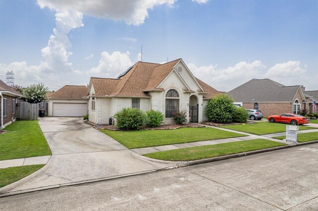 4417 Alamance St, Baytown, TX 77521 - french country inspired facade featuring brick siding, a garage, driveway, and a shingled roof