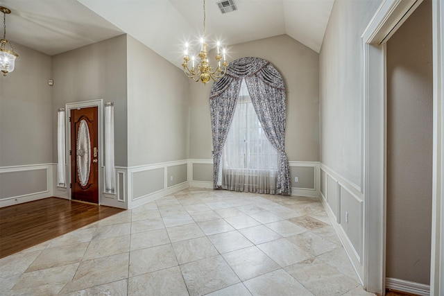4417 Alamance St, Baytown, TX 77521 - foyer with a chandelier, a decorative wall, lofted ceiling, and wainscoting