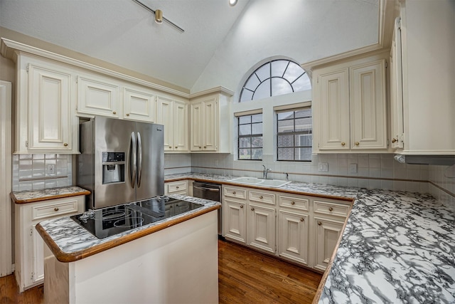 4417 Alamance St, Baytown, TX 77521 - kitchen with stainless steel appliances, backsplash, cream cabinetry, dark wood-style floors, and a kitchen island