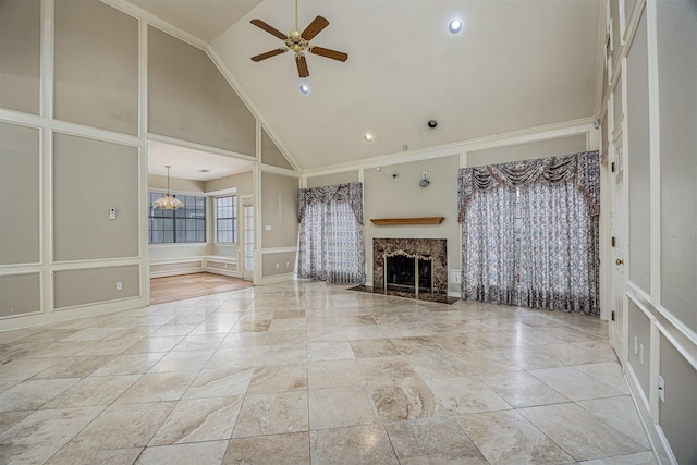 4417 Alamance St, Baytown, TX 77521 - unfurnished living room with a decorative wall, a ceiling fan, high vaulted ceiling, a premium fireplace, and wainscoting