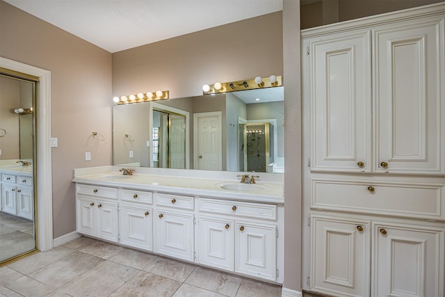 4417 Alamance St, Baytown, TX 77521 - full bathroom featuring double vanity and baseboards