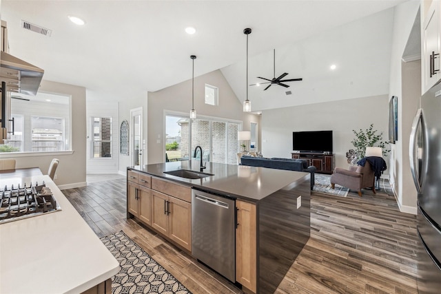 2802 Tarragon Crest Dr, Katy, TX 77494 - kitchen featuring appliances with stainless steel finishes, a ceiling fan, high vaulted ceiling, dark wood-type flooring, and dark countertops
