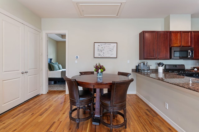 3908 Center St, Houston, TX 77007 - dining room with light wood-style floors and attic access