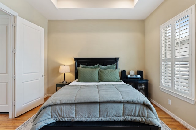 3908 Center St, Houston, TX 77007 - bedroom with wood finished floors, multiple windows, and a tray ceiling