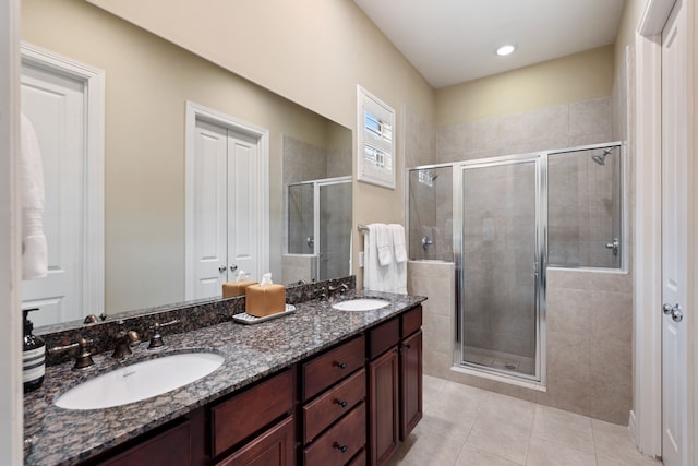 3908 Center St, Houston, TX 77007 - bathroom featuring a stall shower, double vanity, and tile patterned flooring