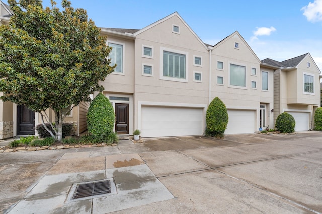 3908 Center St, Houston, TX 77007 - townhome / multi-family property with an attached garage, driveway, and stucco siding
