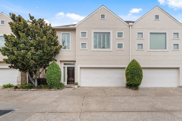 3908 Center St, Houston, TX 77007 - townhome / multi-family property with stucco siding, concrete driveway, and a garage