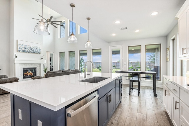 3119 Honeysuckle Way, Katy, TX 77493 - kitchen featuring stainless steel dishwasher, healthy amount of natural light, light wood-type flooring, light countertops, and recessed lighting