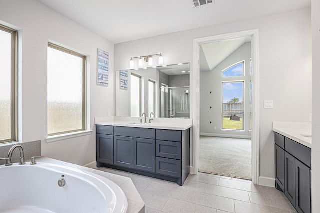 3119 Honeysuckle Way, Katy, TX 77493 - bathroom featuring vanity, a shower stall, a whirlpool tub, tile patterned floors, and vaulted ceiling