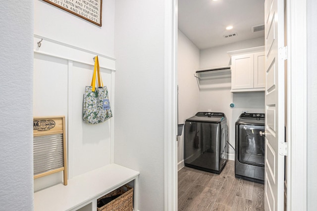 3119 Honeysuckle Way, Katy, TX 77493 - laundry area featuring washer and clothes dryer, cabinet space, light wood-style floors, and recessed lighting