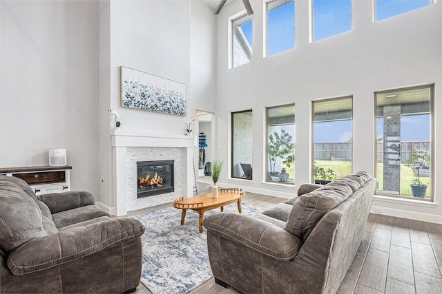 3119 Honeysuckle Way, Katy, TX 77493 - living area featuring wood finished floors, a glass covered fireplace, and a high ceiling