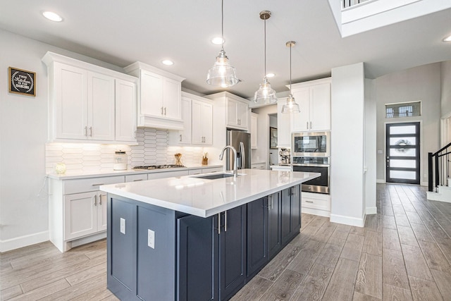 3119 Honeysuckle Way, Katy, TX 77493 - kitchen with appliances with stainless steel finishes, light wood-style floors, white cabinetry, and recessed lighting
