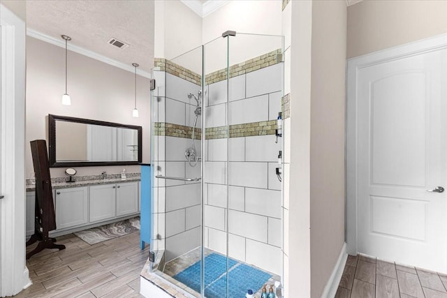 20012 Fm 523, Angleton, TX 77515 - full bath featuring a stall shower, vanity, crown molding, wood tiled floors, and a textured ceiling