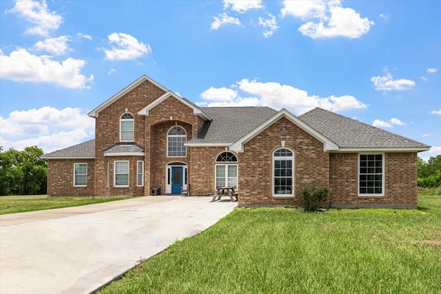 20012 Fm 523, Angleton, TX 77515 - traditional home with roof with shingles, a front yard, and brick siding