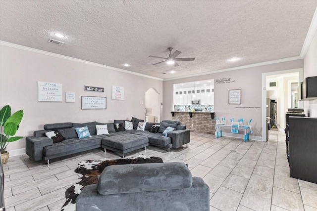 20012 Fm 523, Angleton, TX 77515 - living area with a ceiling fan, arched walkways, ornamental molding, a textured ceiling, and recessed lighting