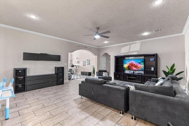 20012 Fm 523, Angleton, TX 77515 - living room featuring a ceiling fan, arched walkways, a textured ceiling, ornamental molding, and recessed lighting
