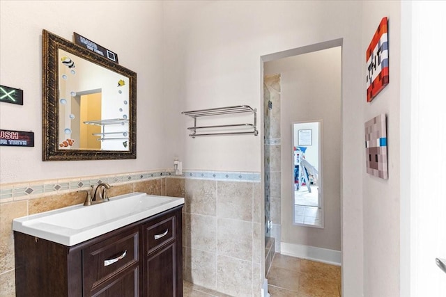 20012 Fm 523, Angleton, TX 77515 - full bathroom featuring tile walls, vanity, a shower, tile patterned flooring, and wainscoting
