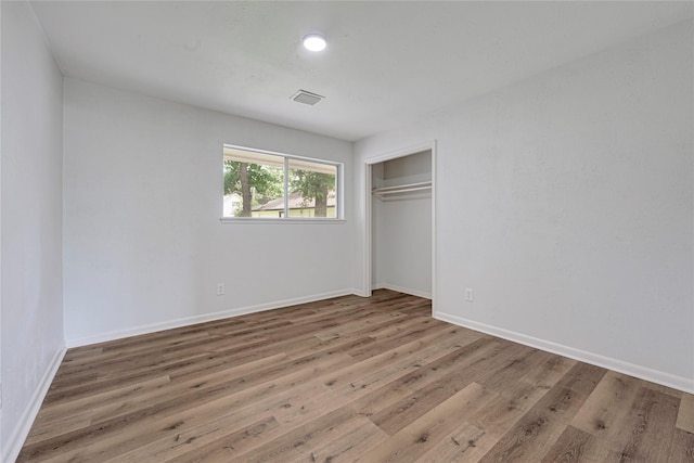 910 Woodchurch Ln, Houston, TX 77073 - unfurnished bedroom featuring wood finished floors and a closet
