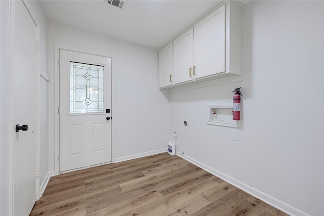 910 Woodchurch Ln, Houston, TX 77073 - laundry room with cabinet space, hookup for a washing machine, light wood-style floors, hookup for an electric dryer, and hookup for a gas dryer