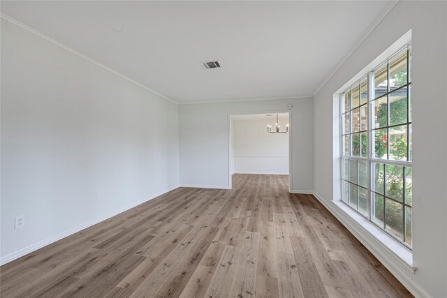 910 Woodchurch Ln, Houston, TX 77073 - spare room featuring a chandelier, wood finished floors, and crown molding